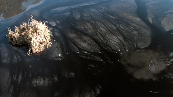 The surface of the sludge lagoon. Dolly movement of camera alt