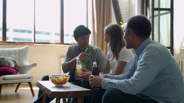Three Friends Talk To Each Other and Eat Food at Home alt