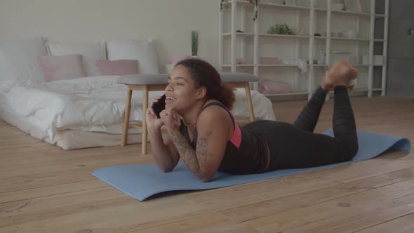 Cheerful Woman Chatting on Phone After Workout alt
