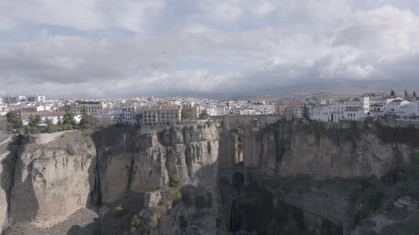 Aerial: Ronda Spain, famous for old stone bridge crossing deep canyon alt