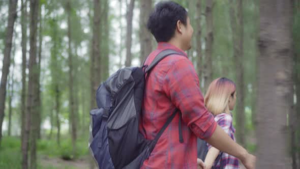 Hiker Asia backpacker couple adventure feeling freedom walking in forest, enjoy their holidays. alt
