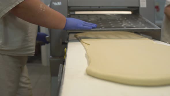 Preparation and Rolling Dough for Making Buns and Croissants. Production for the Production alt