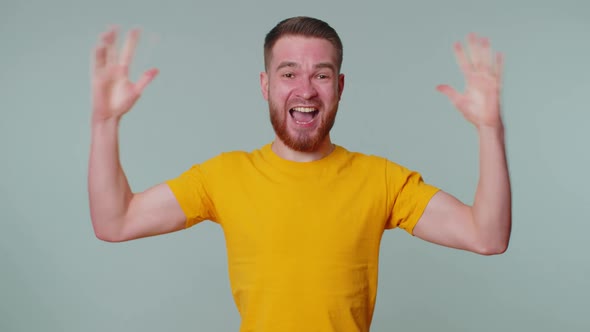 Stylish Man in Tshirt Shouting Raising Fists in Gesture I Did It Celebrating Success Winning alt
