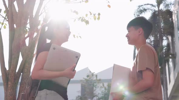 Education and student. Two Asian student teenagers talking on walkway in college alt
