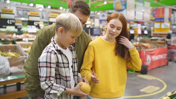 Portrait of Happy Family with Child Boy in Food Store