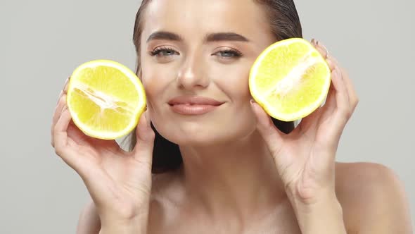 Joyful Girl with Perfect Skin Playing with Fresh Fruits alt