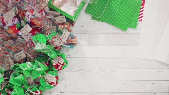Flat lay. Step by step. Packaging homemade fudge and cookies into a Christmas gift box. alt