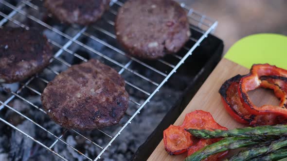 Beef Burgers Cutlets are Roasting on the Charcoal Barbecue Grill alt