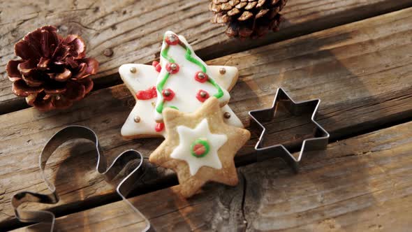 Christmas cookies and cookie cutters on wooden table alt