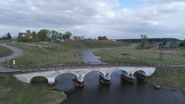 Aerial view of old village with ruined buildings on bank of the river 10 alt
