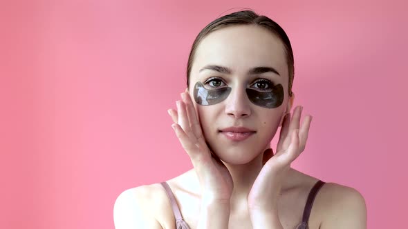 Head shot portrait close up smiling young woman with under eye moisturizing patches mask alt