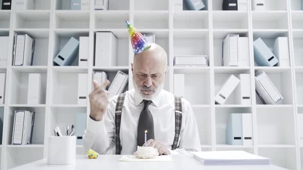 Sad businessman celebrating a lonely birthday