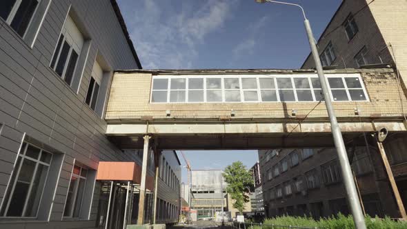 Glass pedestrian tunnel between buildings at a height of from Soviet times . dolly camera shot