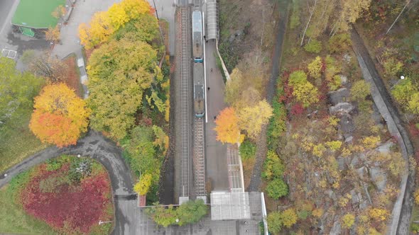 Top View Over Tram Train Stop and Commuter Walking Autumn Aerial