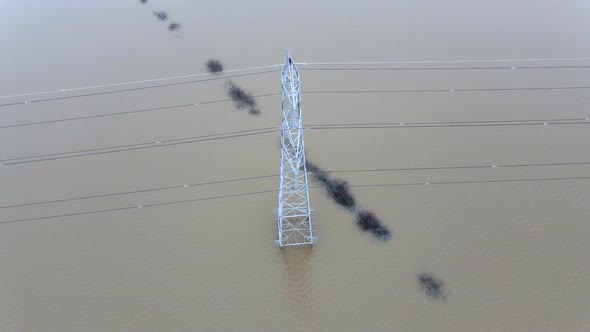 An Electricity Pylon in Deep Water in a Floodwaters Causing Power Cuts alt