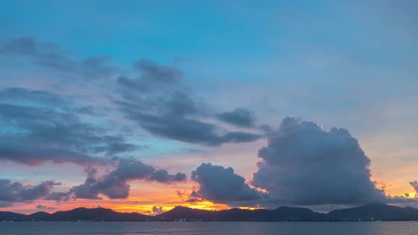 Time Lapse Dark Clouds Cover The Mountain Range In Stunning Twilight. alt