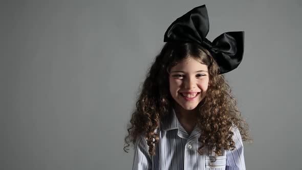 Young girl with large black bow in hair alt