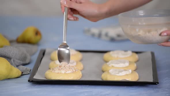 Woman Making Open Buns with Cream Cheese and Pear