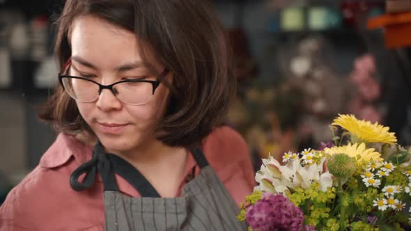 Close Up of Woman Composing a Bunch of Flowers. Selling Floral Arrangement. Professional Florist