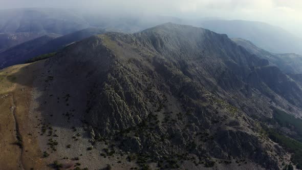 Mountains on foggy day with cloudy sky alt