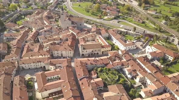 Top down aerial view of a small historic town Venzone in Northern Italy with red tiled roofs alt