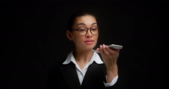 Business Woman Listens to an Voice Message on Her Smartphone