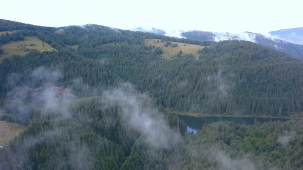 Majestic Aerial Drone Shot Rising through the Valley Fog and Mist to Reveal a River Cutting through alt