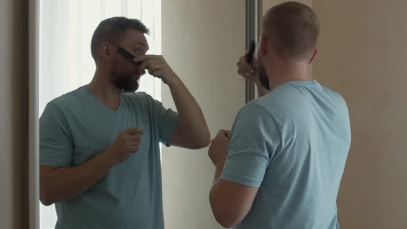 Bearded Man Combing His Beard