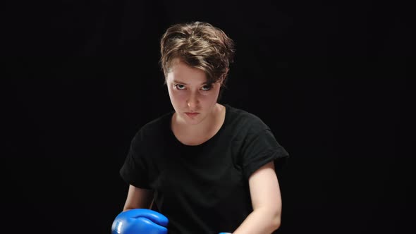 Young Furious Caucasian Woman Boxing Shadow Looking at Camera alt
