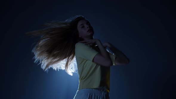 Talented Woman Dancing Contemporary on Background with White Light in Studio alt