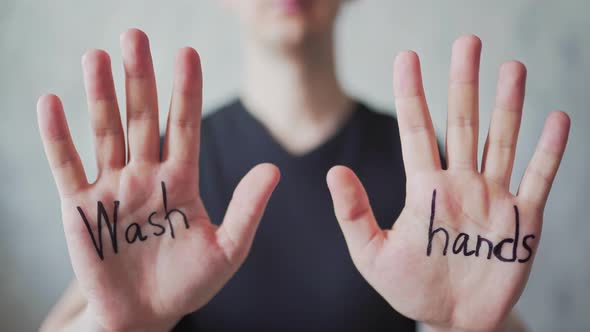 Text - Wash Hands, Written on Men's Hands. Protection From the Covid-19 Virus. The Concept of