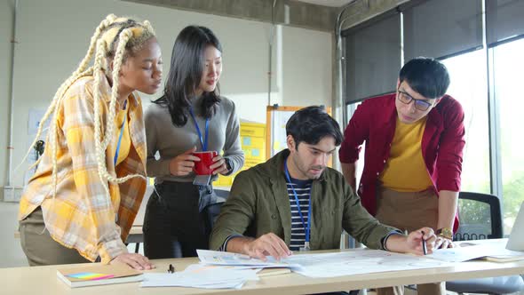 brainstorming about mobile app interface workflow design on table with coworker alt