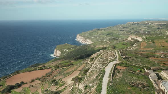 AERIAL: Mediterranean Sea Crashes Waves on Dingli Cliff During Winter in Malta