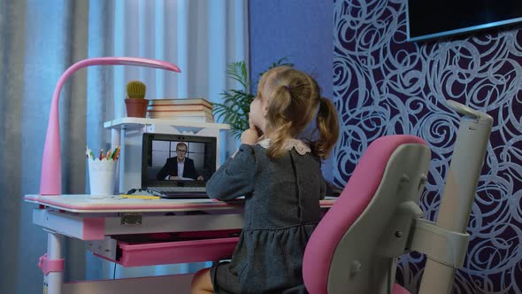 Child Girl Pupil Studying Homework with Man Teacher on Laptop Computer During Online Lessons at Home alt