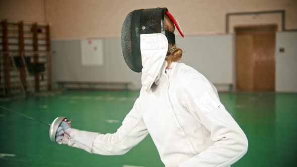 Two Young Women at Fencing Training in the Gym - a Ginger Woman Triumphs alt