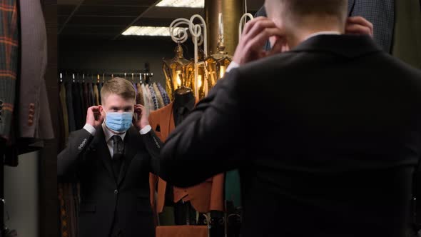 Man putting on a protective mask in front of a mirror alt