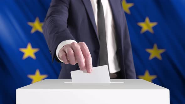Voting. Man Putting a Ballot with European Union Flag on Background.