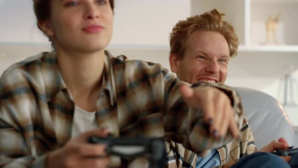 Playful Couple Enjoy Joysticks Game at Home Closeup alt