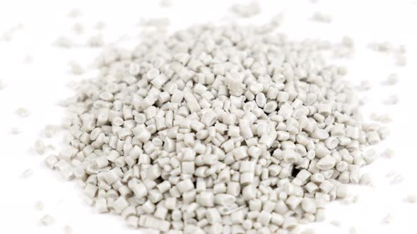 Secondary granule made of polypropylene, white plastic pellets crumbles on isolated background