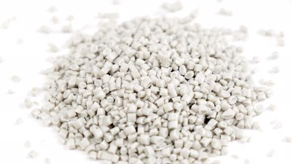 Secondary granule made of polypropylene, white plastic pellets crumbles on isolated background alt
