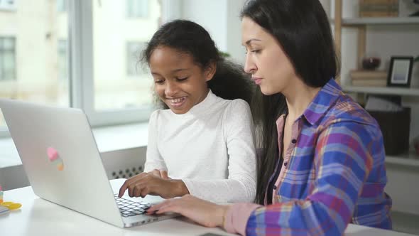 Medium Shot of Happy Black Girl at Home Talking with Aultd Teacher From Secondary School Helping Her alt