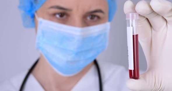 Female Nurse Holding Testing Blood Samples 