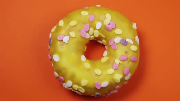Donut with Icing on an Orange Background