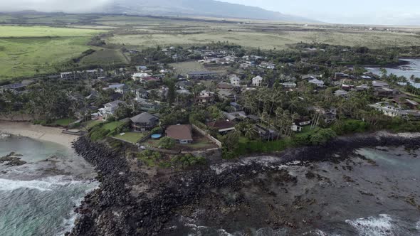 Zoom out aerial view of the Paia region, on the Maui Island of Hawaii, in the United States. alt