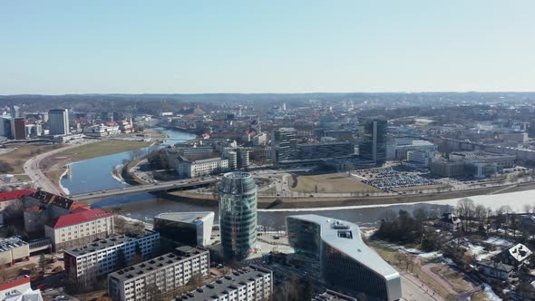 AERIAL: Rotating Shot of Vilnius Panorama with River Bank Neris and Office Buildings in Background
