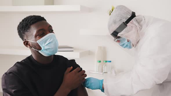 African American Black Man with Face Mask Receiving Vaccine Against Coronavirus alt