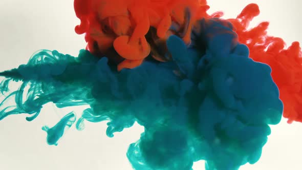 Bright Blue and Red Inks Injecting From Syringes Under Water alt