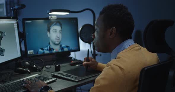 Graphic Designers Discussing Via a Video Call alt