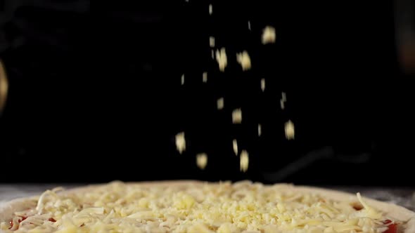A Cheese is Falling on a Pizza Closeup in Slow Motion