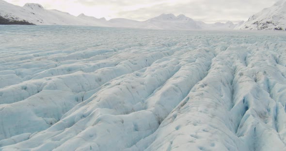 Wide aerial helicopter shot of small passenger prop plane taking off from rural airfield, drone foot alt